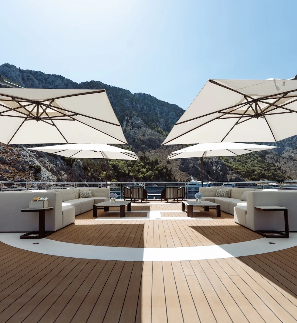 a deck with a view of mountains and a pool aboard AFTER YOU Yacht for Charter