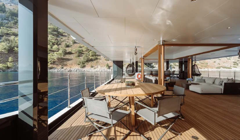 a room with a table chairs and a large window aboard AFTER YOU Yacht for Charter