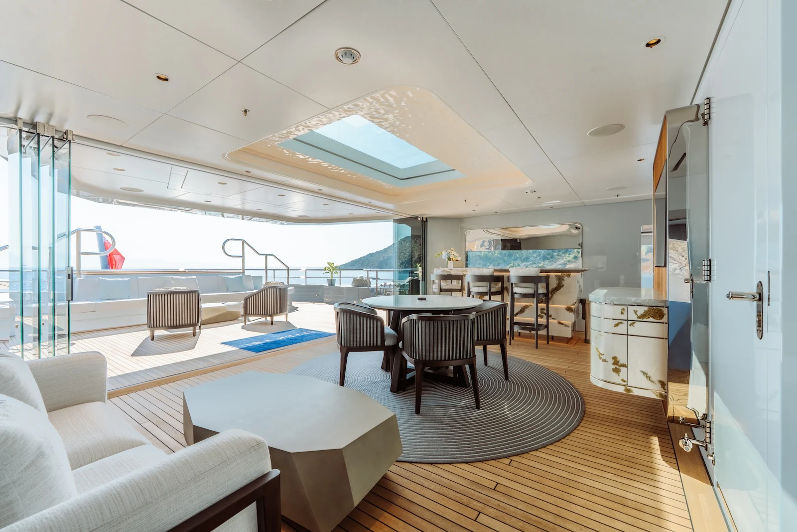 a room with a table chairs and a large window aboard AFTER YOU Yacht for Charter