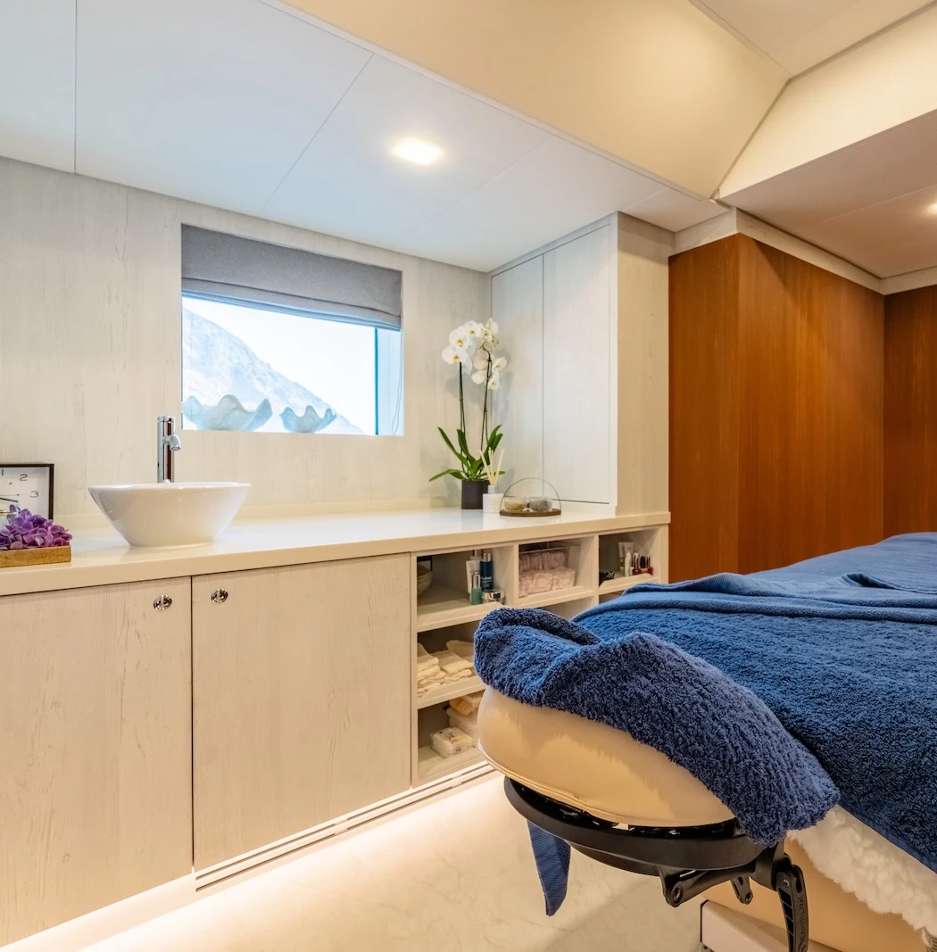 a bathroom with a sink and a chair aboard AFTER YOU Yacht for Charter