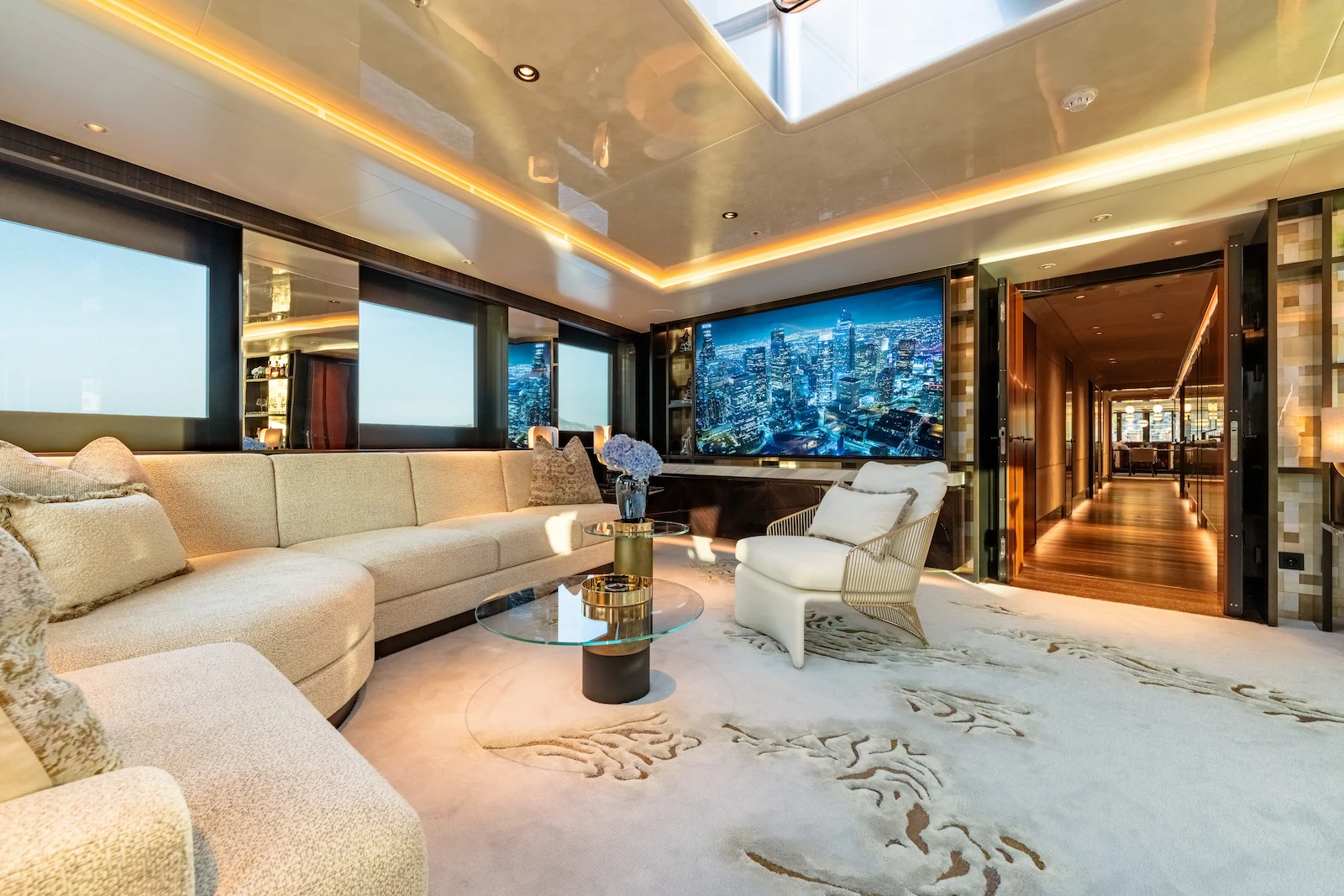 a living room with a large white couch and a large window aboard AFTER YOU Yacht for Charter