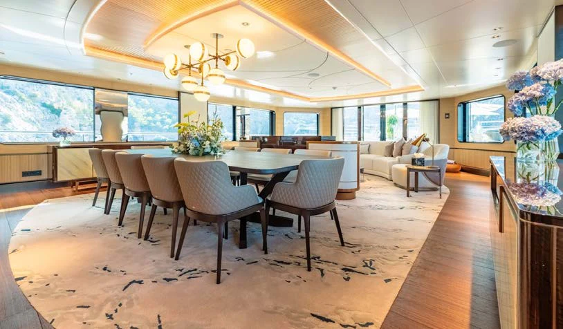 a large room with tables and chairs aboard AFTER YOU Yacht for Charter