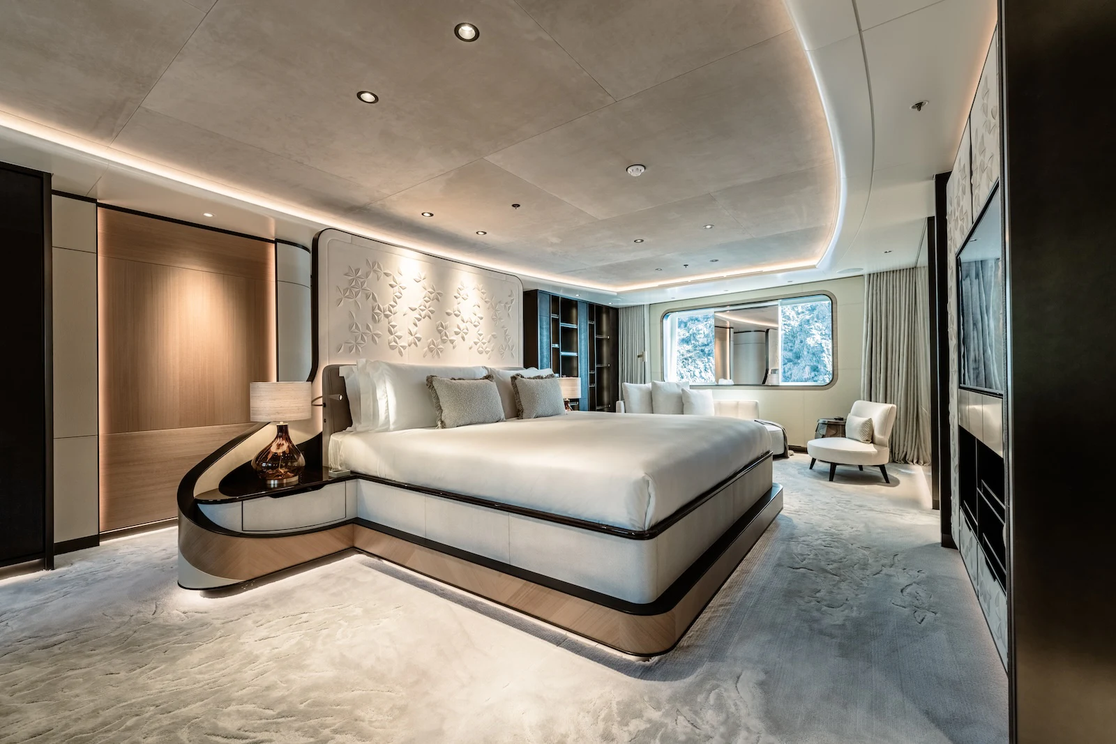 a large living room with a large white couch and a large window aboard AFTER YOU Yacht for Charter