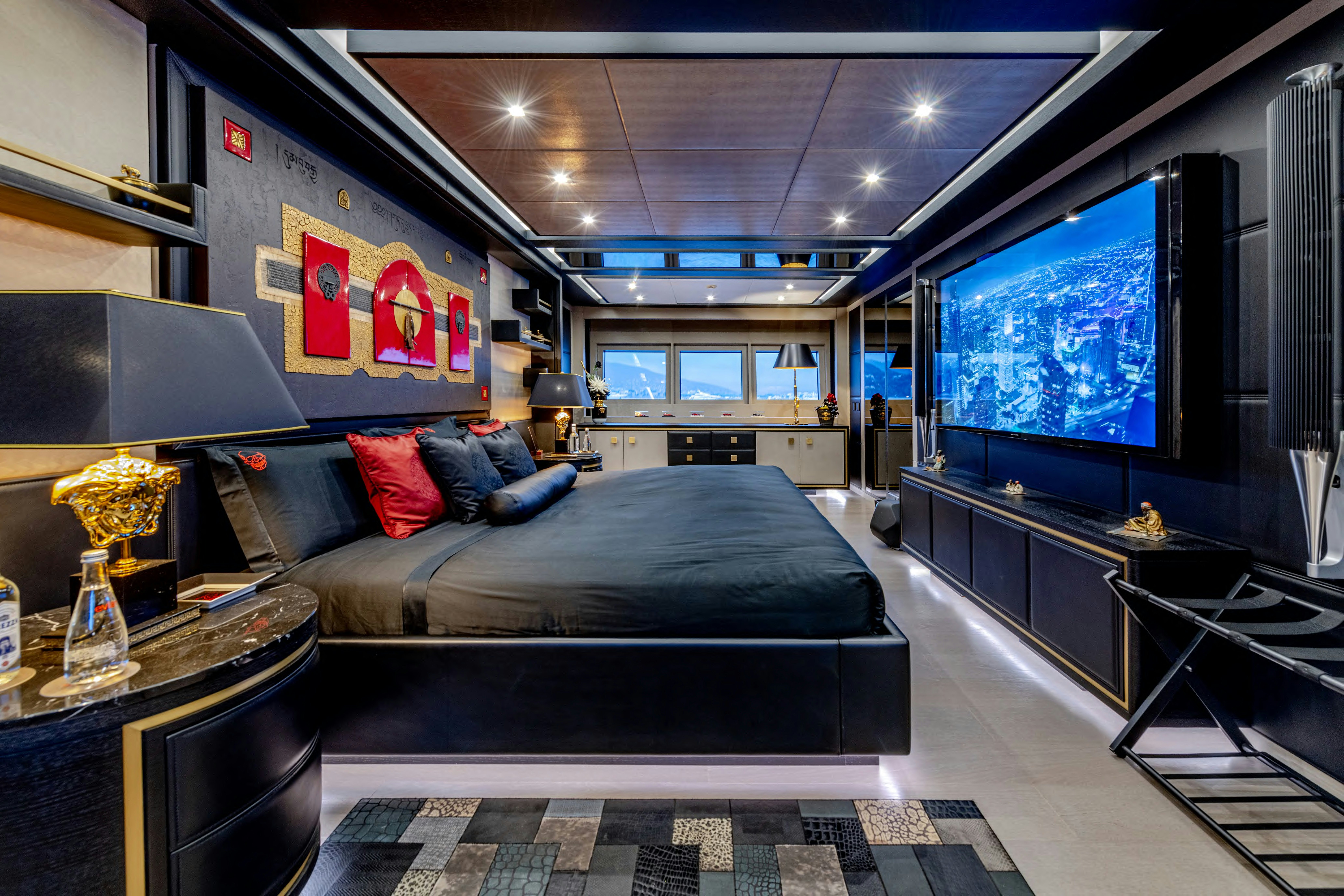 a bedroom with a bed and a tv aboard BLACK LEGEND Yacht for Sale