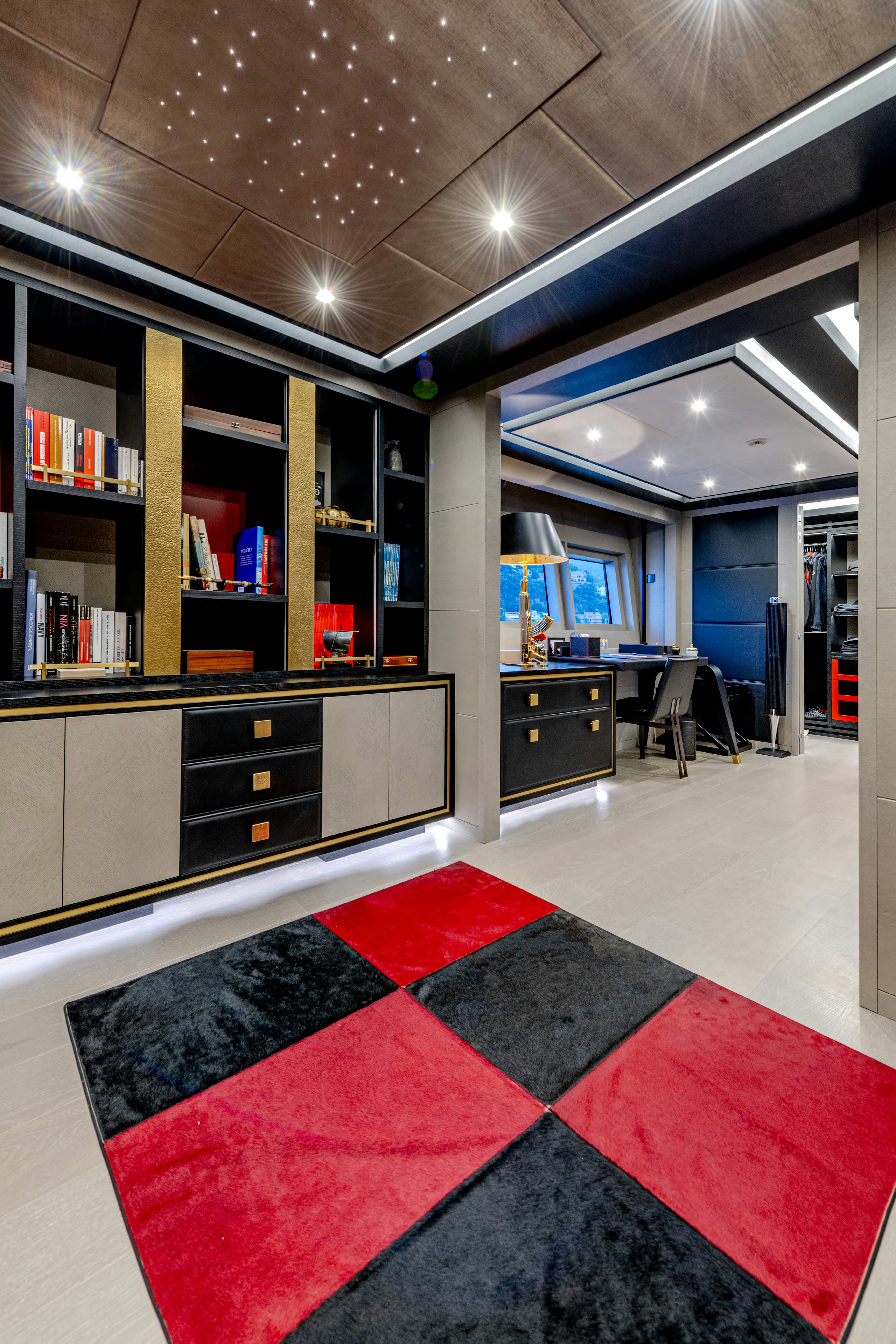 a room with a rug and a desk and a bookcase aboard BLACK LEGEND Yacht for Sale