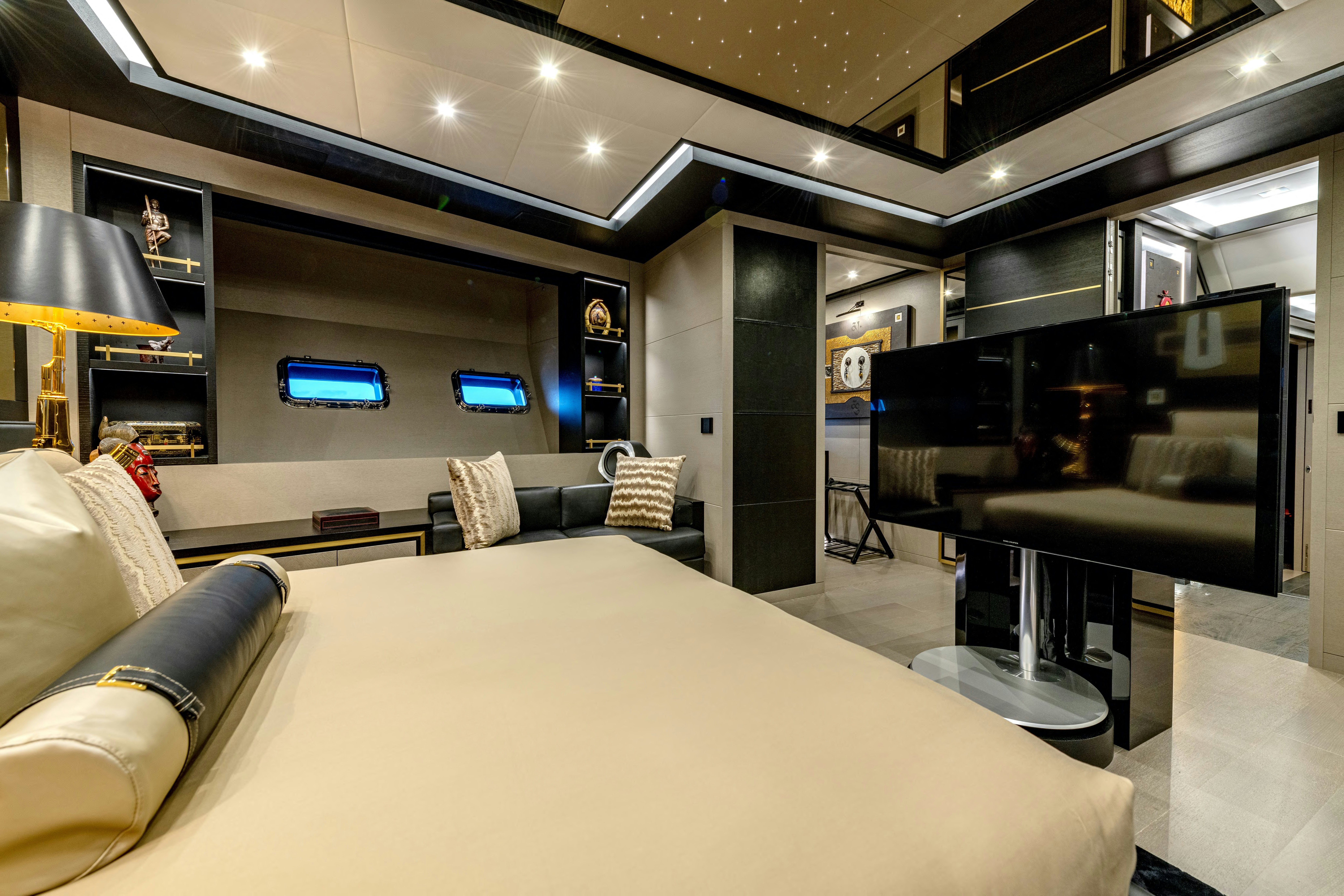 a room with a bed and a couch aboard BLACK LEGEND Yacht for Sale
