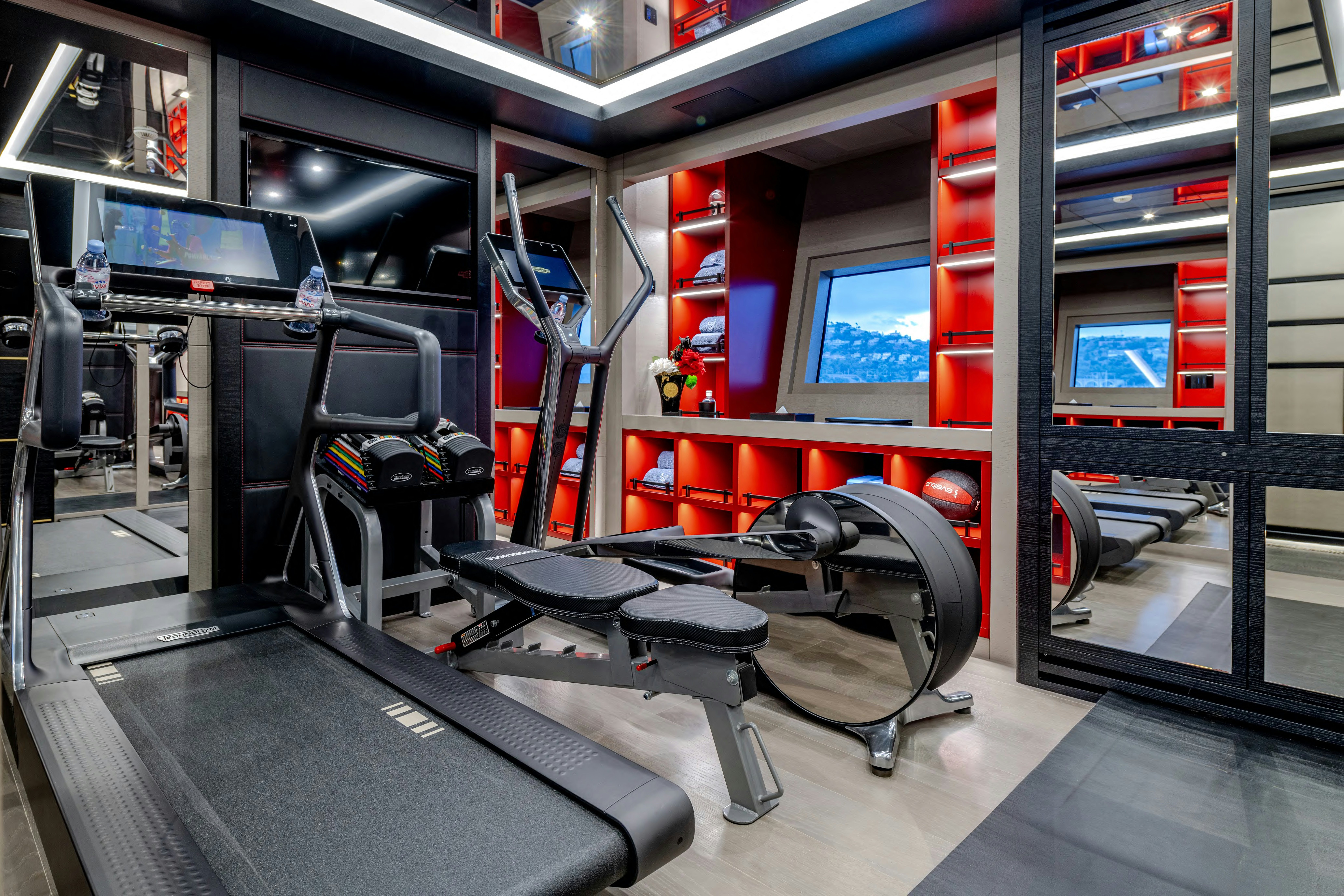 a room with treadmills and treadmills aboard BLACK LEGEND Yacht for Sale