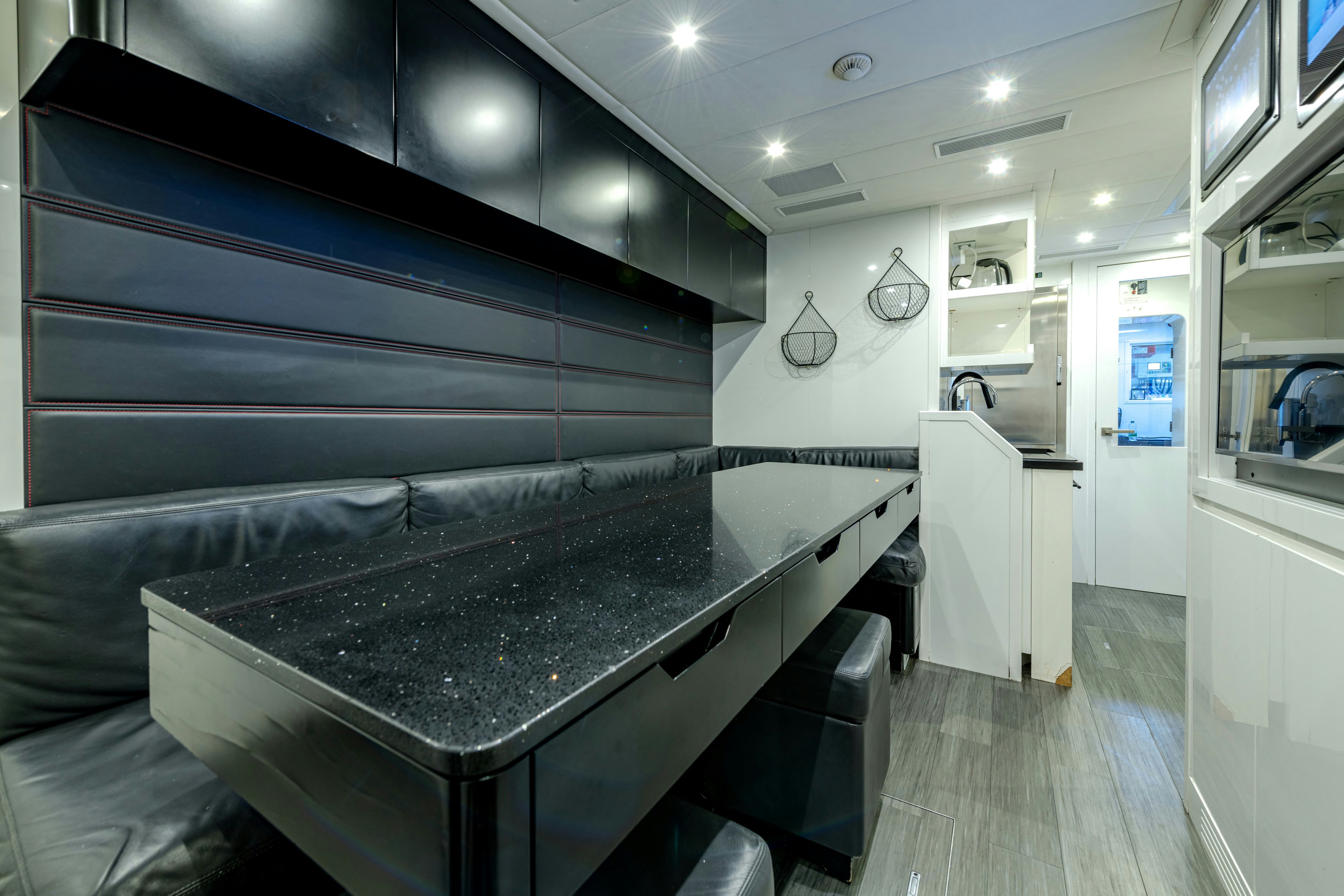 a kitchen with a bar and a bar aboard BLACK LEGEND Yacht for Sale