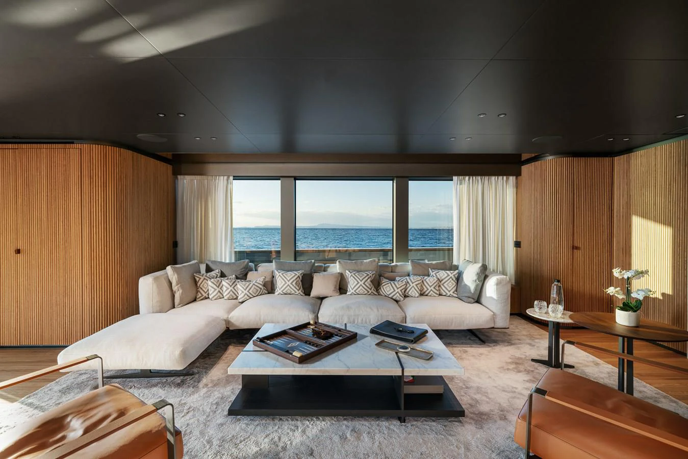 a living room with a large window aboard INVICTUS Yacht for Sale