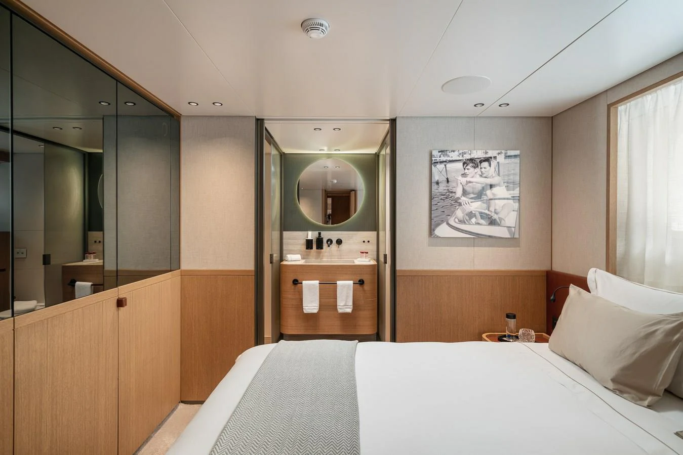 a hotel room with a bed and mirror aboard INVICTUS Yacht for Sale