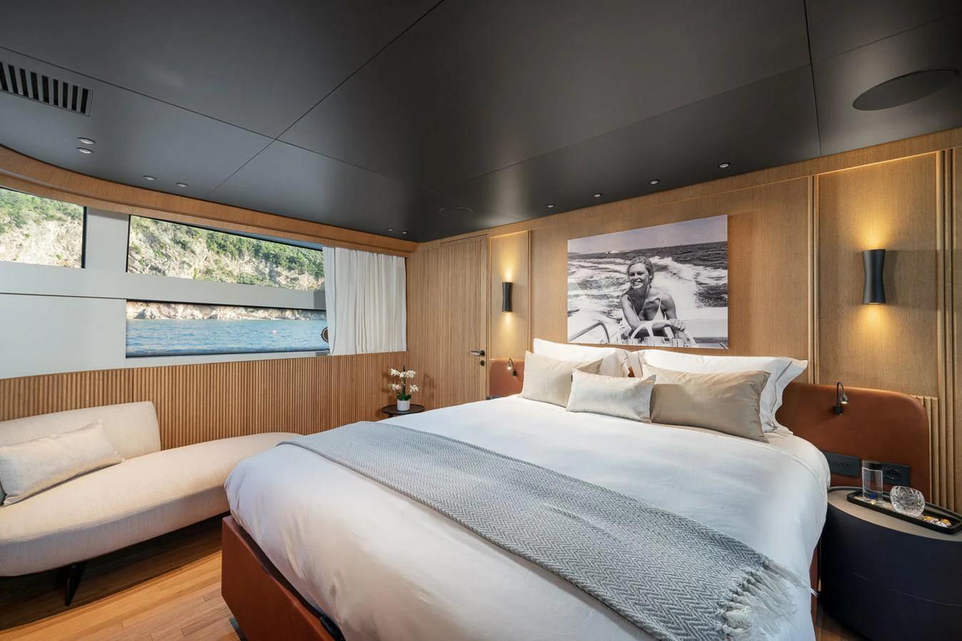 a room with a bed and a couch aboard INVICTUS Yacht for Sale