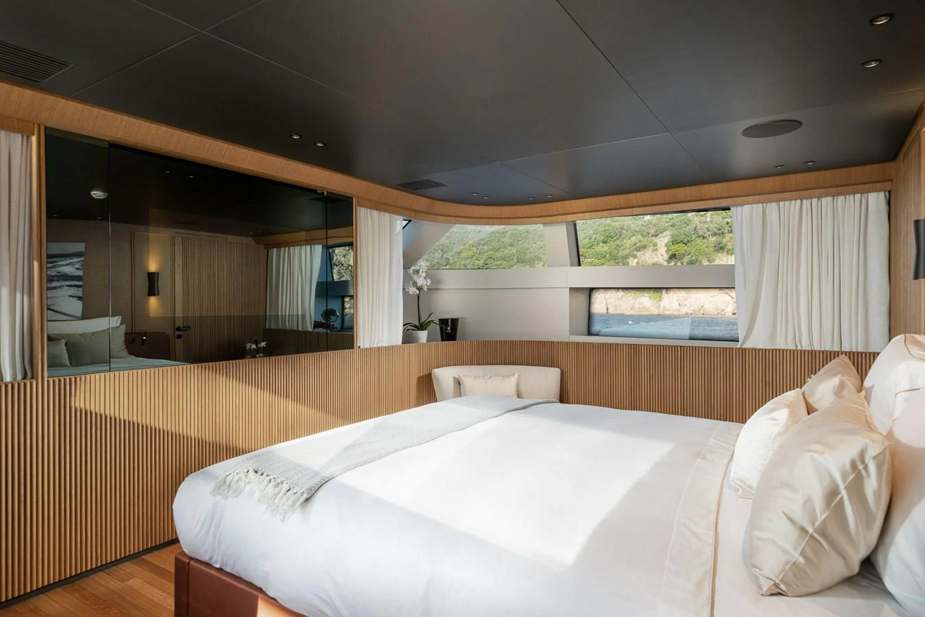 a room with a bed and a window aboard INVICTUS Yacht for Sale
