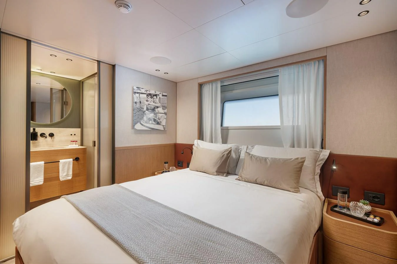 a bedroom with a bed and a mirror aboard INVICTUS Yacht for Sale