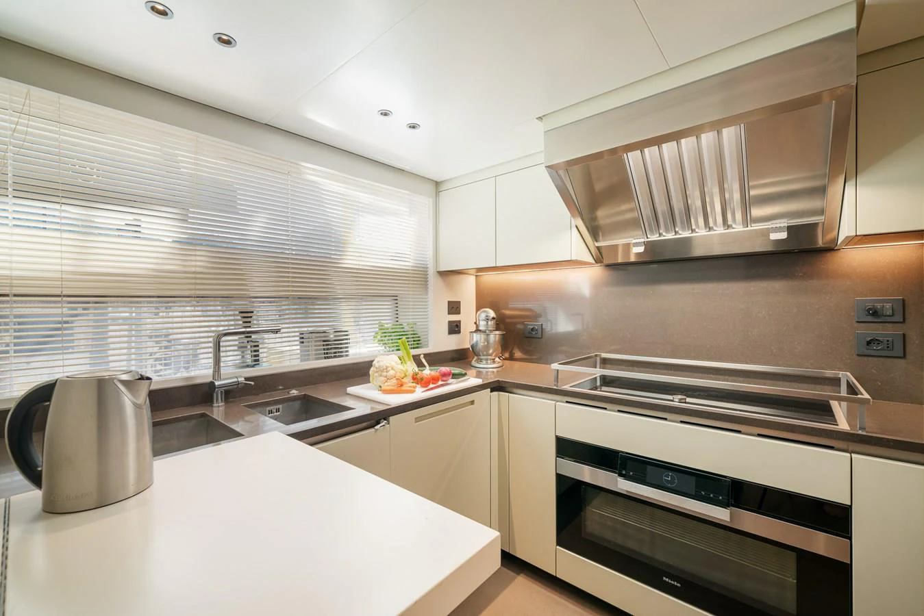 a kitchen with white cabinets aboard INVICTUS Yacht for Sale