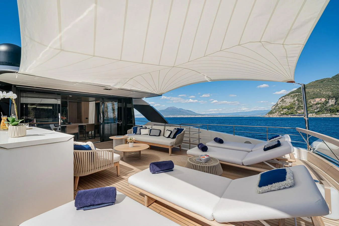 a room with a large white bed and a large body of water aboard INVICTUS Yacht for Sale