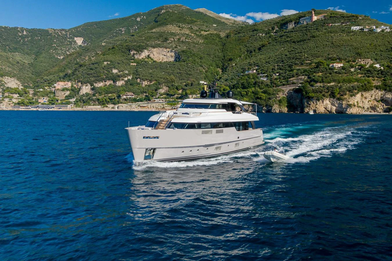 a white boat on the water aboard INVICTUS Yacht for Sale