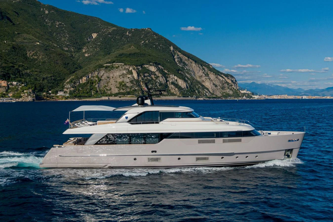 a white yacht on the water aboard INVICTUS Yacht for Sale