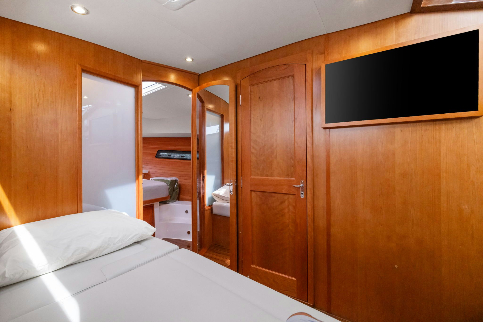 a room with a bed and a television aboard ANNABELLE Yacht for Sale