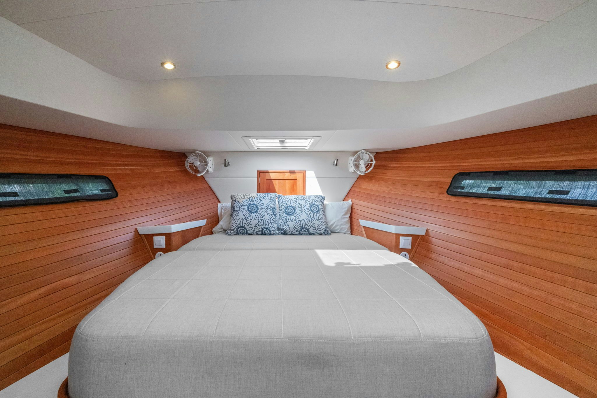 a bed with a white sheet and a wooden headboard aboard ANNABELLE Yacht for Sale