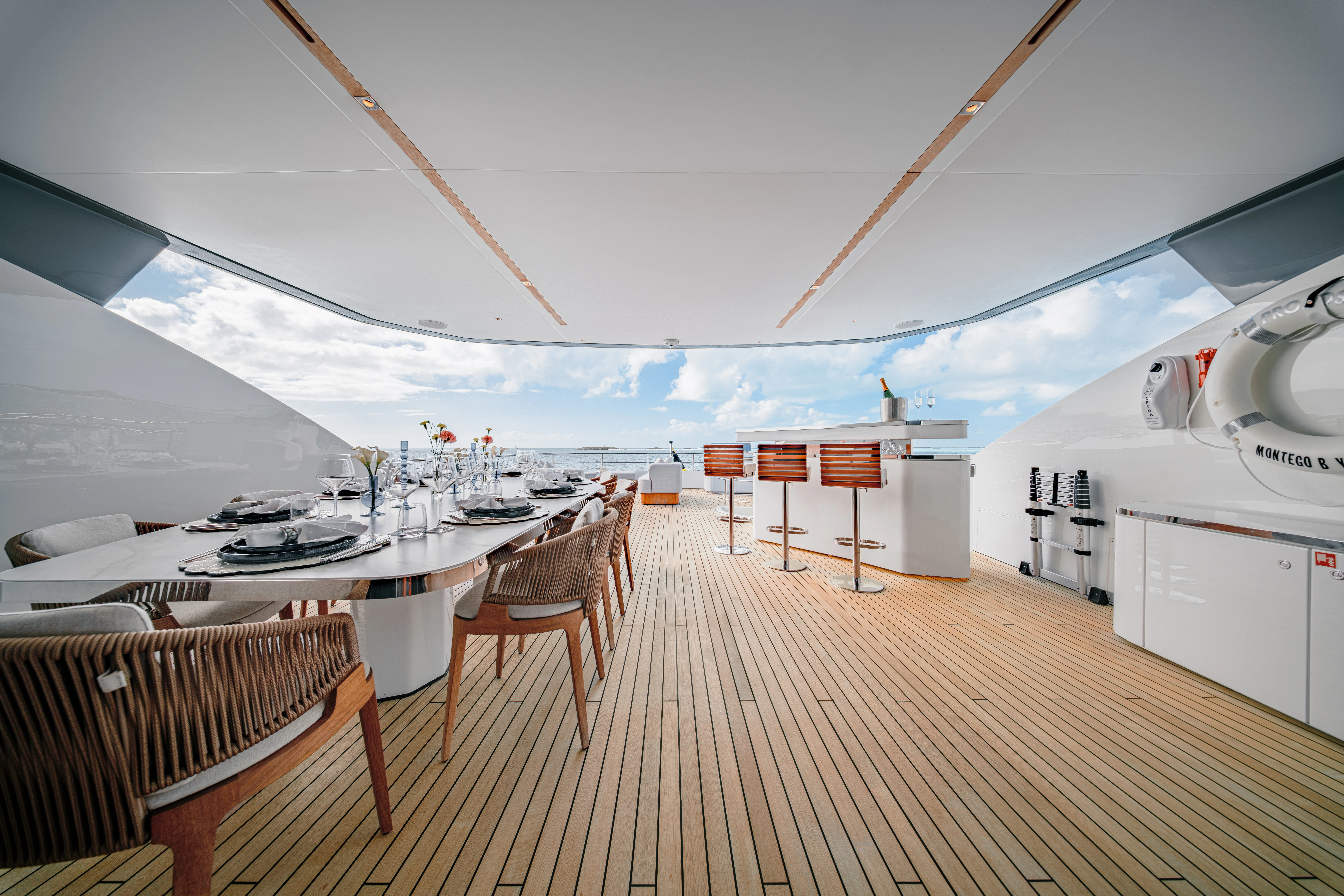 a large white room with a large deck and a large white building with a large white roof and aboard PROPOSITION Yacht for Charter