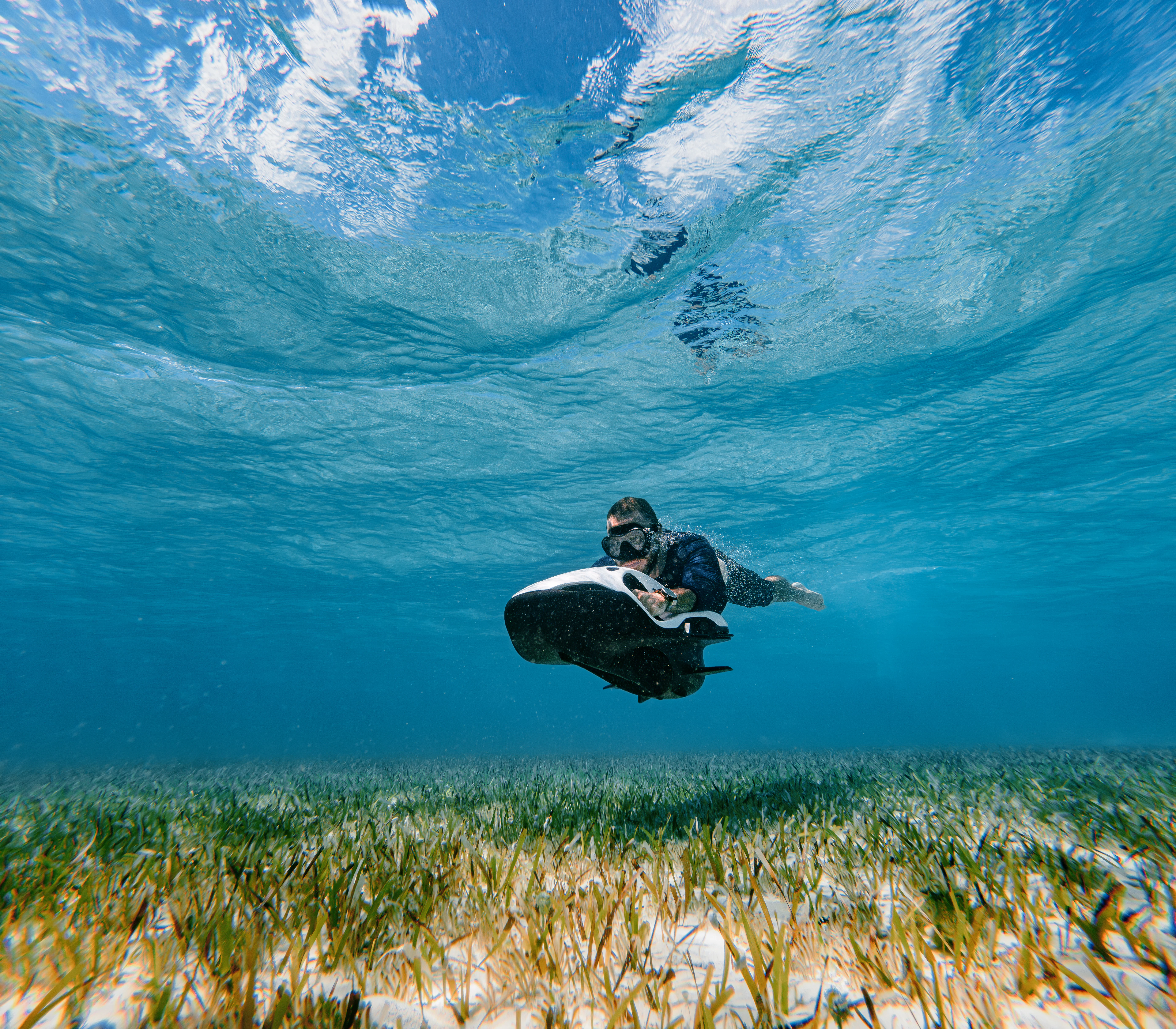 a man carrying a woman on his back in the grass aboard PROPOSITION Yacht for Charter