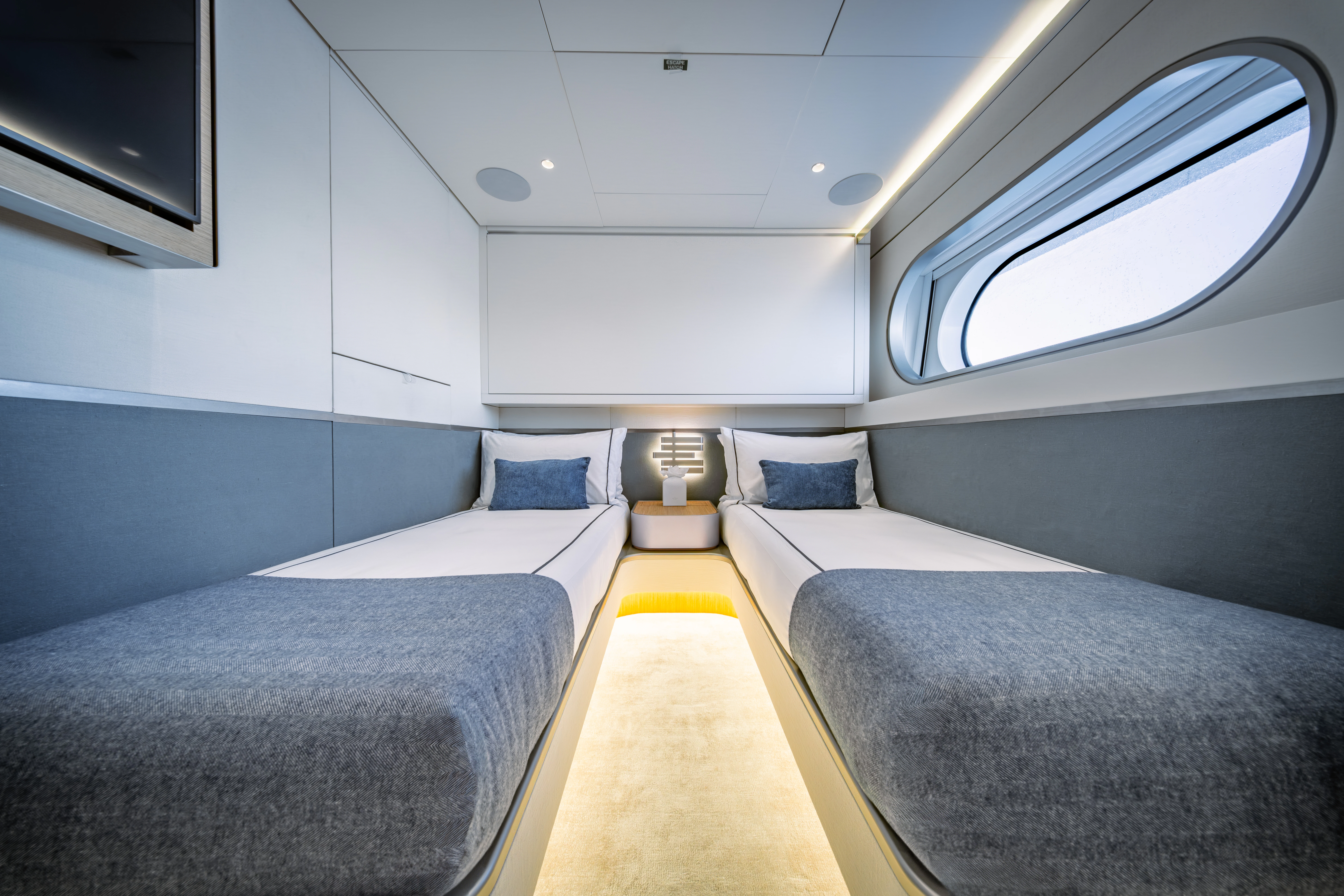 a room with beds and a window aboard PROPOSITION Yacht for Charter