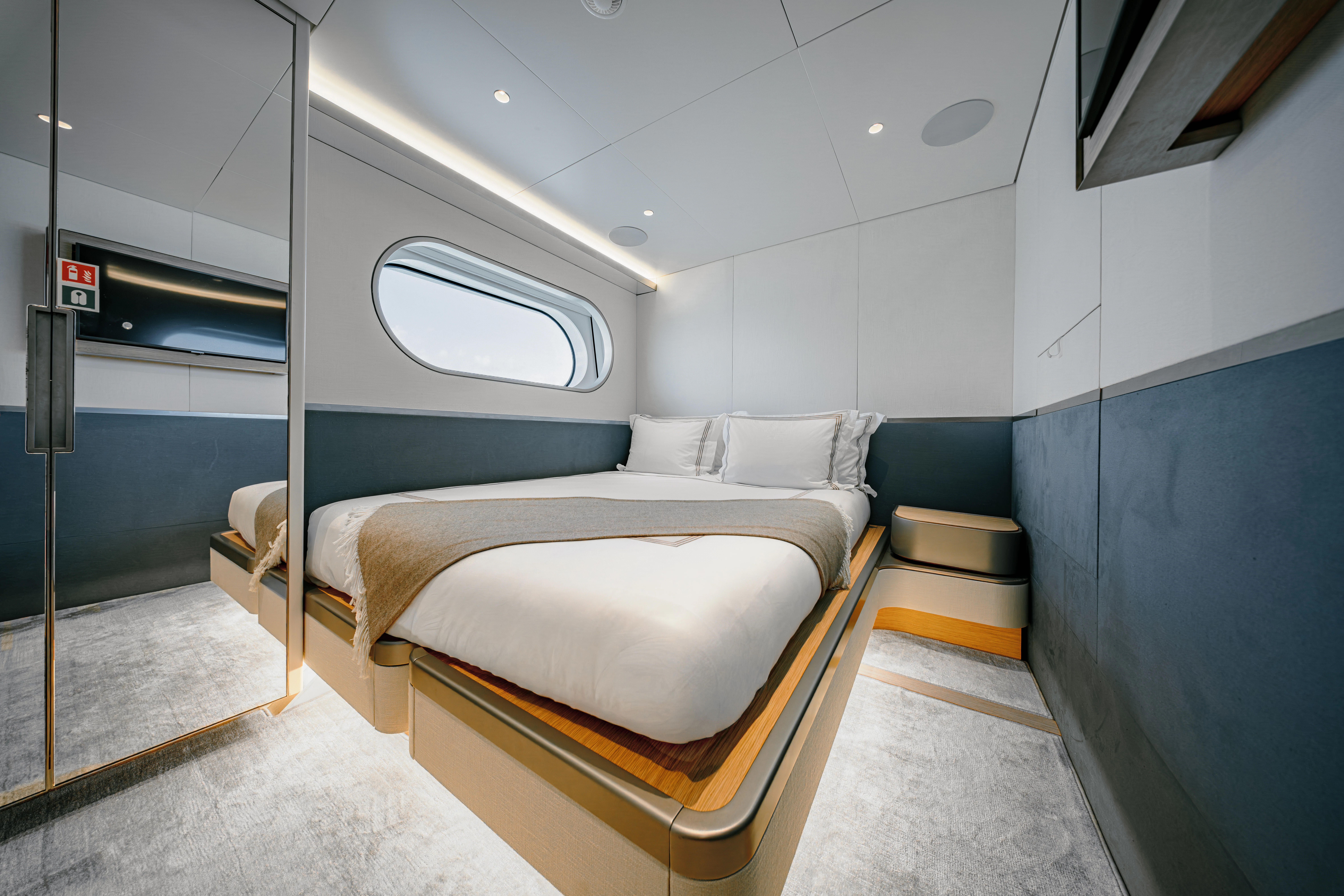 a room with beds and a chair aboard PROPOSITION Yacht for Charter