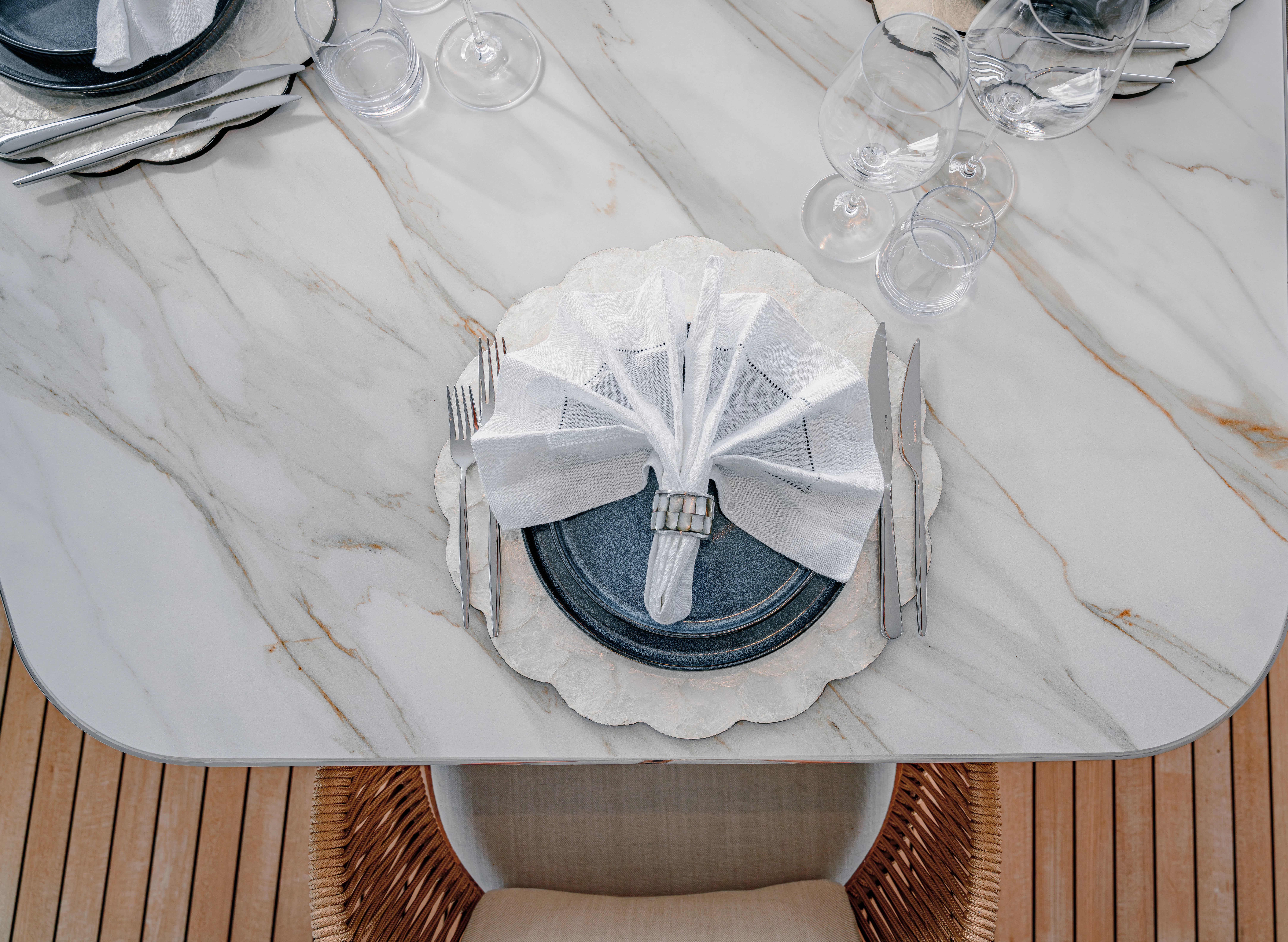 a white plate with silverware on it aboard PROPOSITION Yacht for Charter