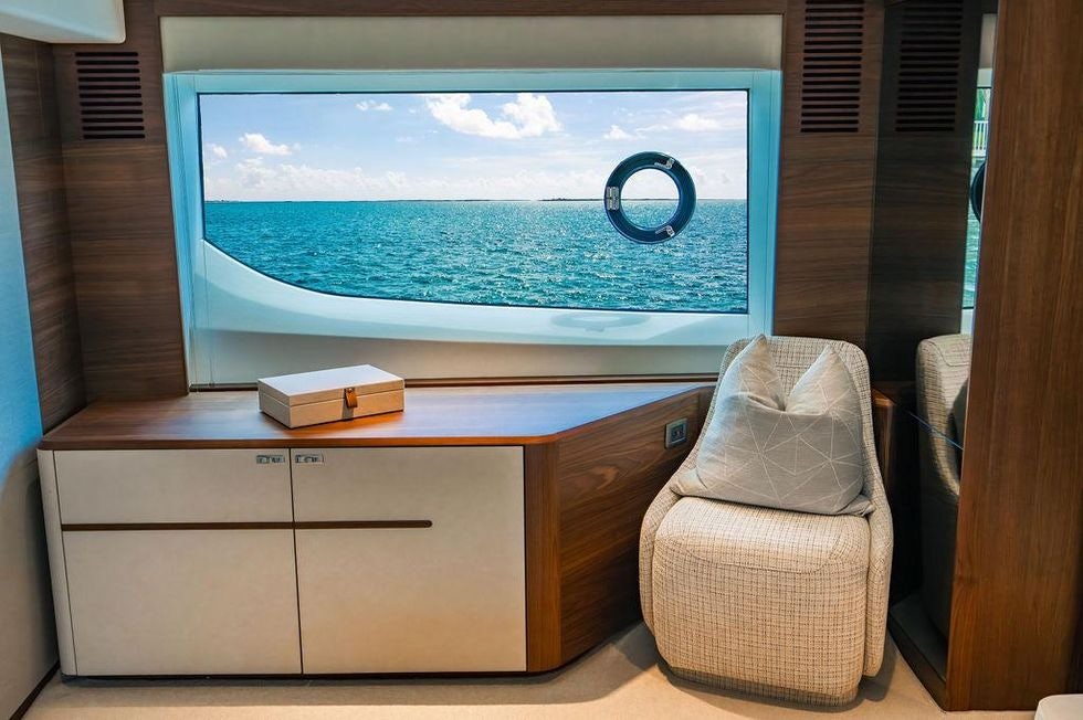 a room with a tv and a chair aboard GYPZY Yacht for Charter