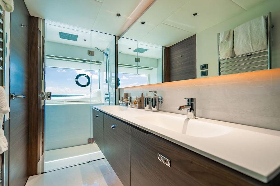 a bathroom with a large mirror aboard GYPZY Yacht for Charter
