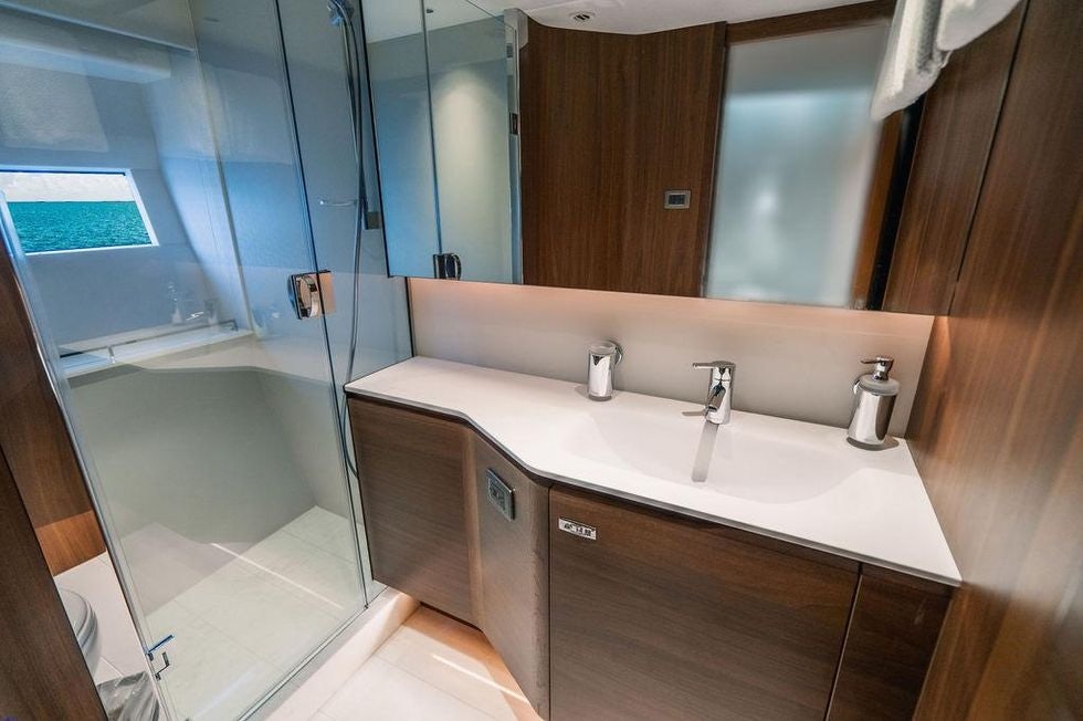a bathroom with a glass shower aboard GYPZY Yacht for Charter