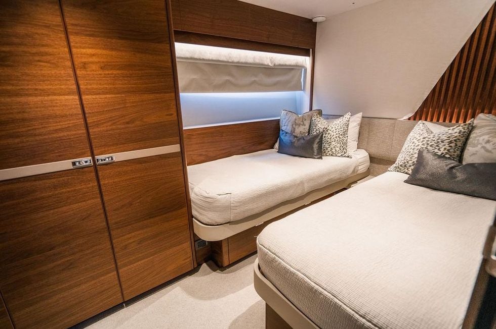 a room with a bed and a closet aboard GYPZY Yacht for Charter