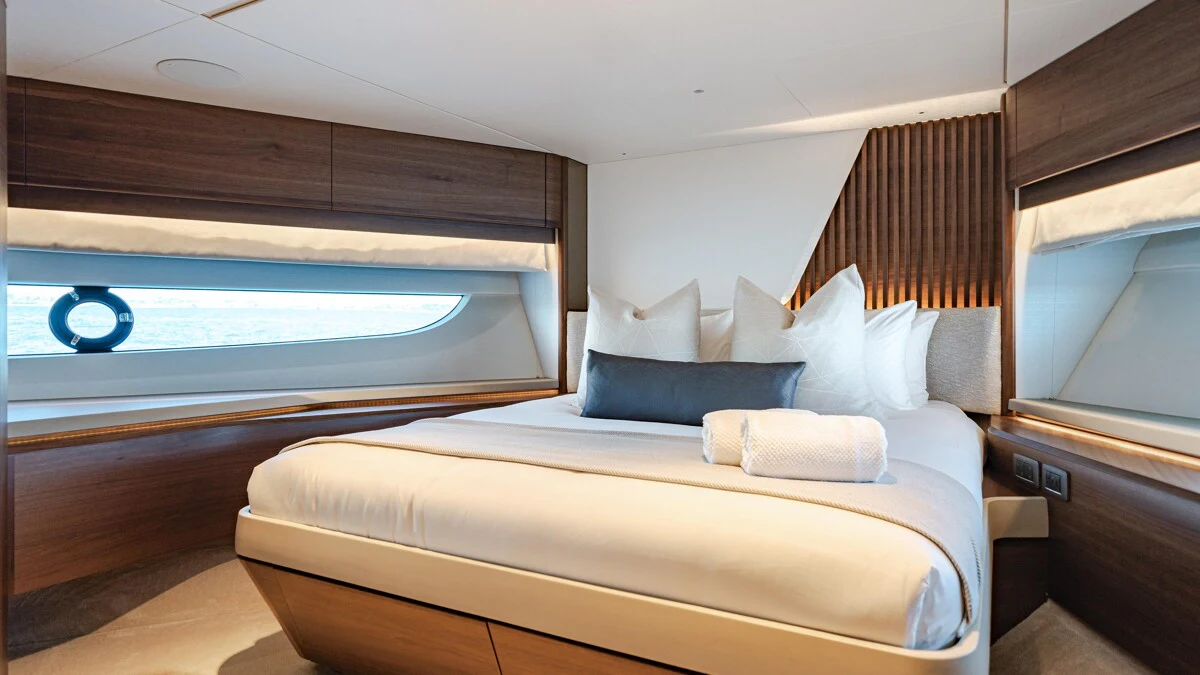 a bed with a white bed aboard GYPZY Yacht for Charter