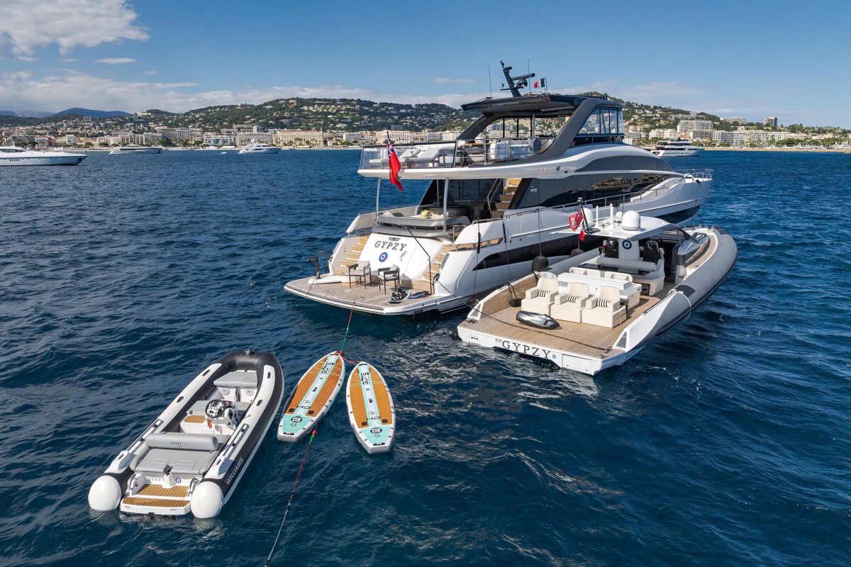 a couple of boats on a body of water aboard GYPZY Yacht for Charter
