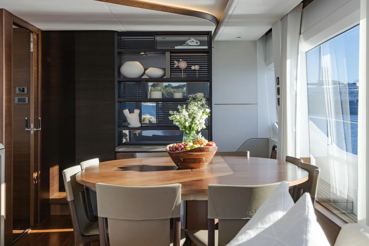 a table with chairs and a bowl of salad on it aboard GYPZY Yacht for Charter