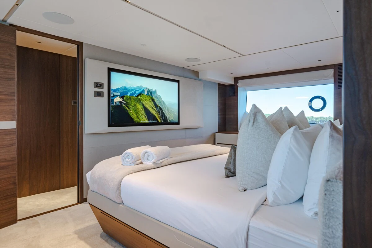 a room with a bed and a television aboard GYPZY Yacht for Charter