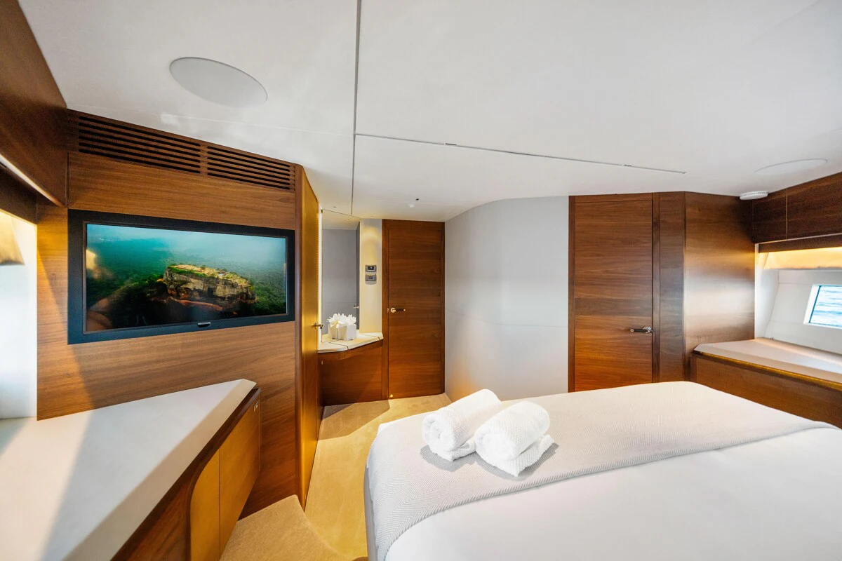 a room with a bed and a television aboard GYPZY Yacht for Charter