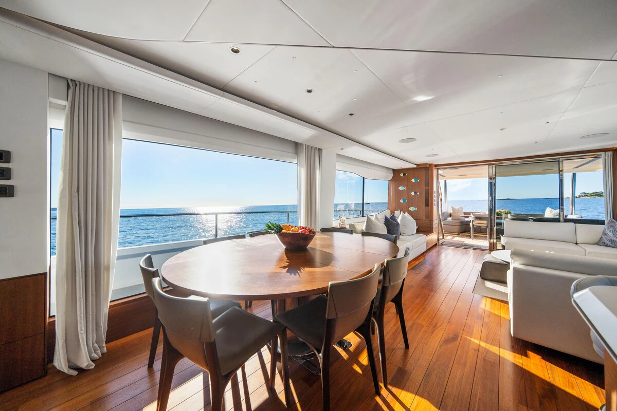 a large dining table in a living room aboard GYPZY Yacht for Charter