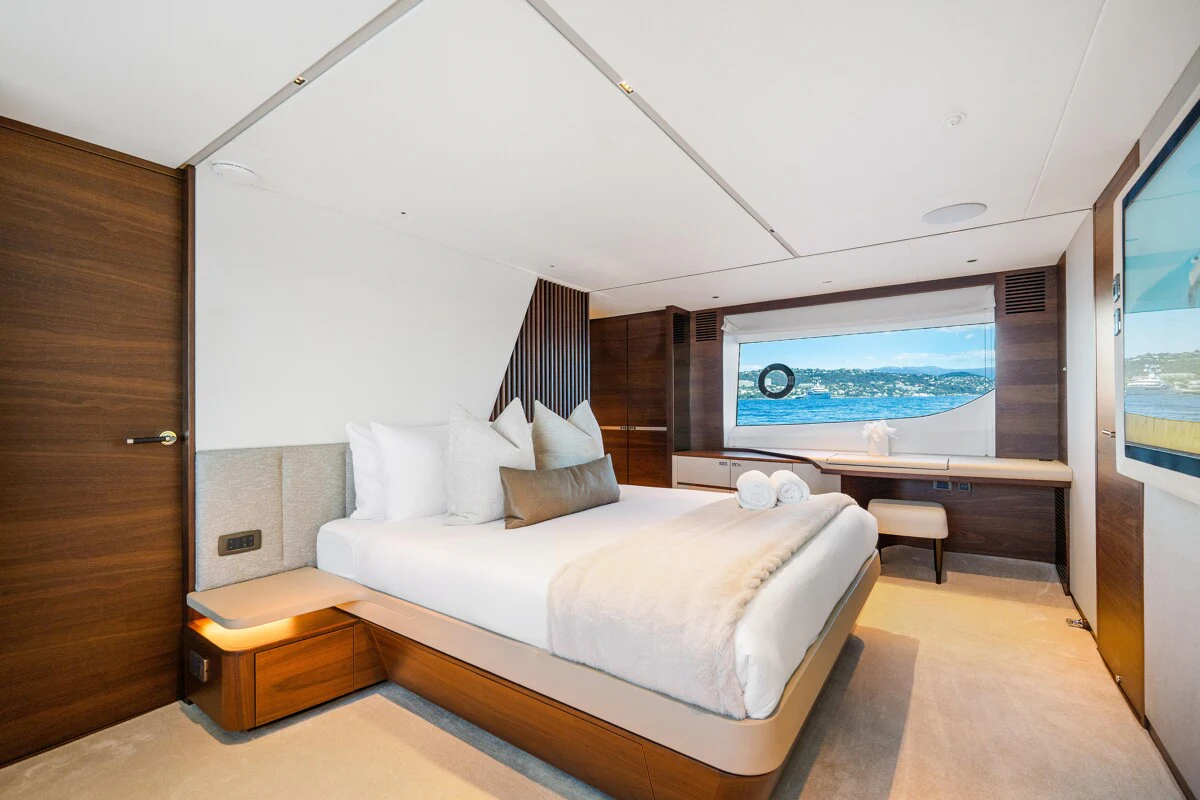 a room with a bed and a tv aboard GYPZY Yacht for Charter