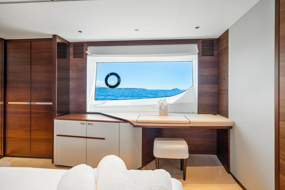 a room with a tv and a chair aboard GYPZY Yacht for Charter