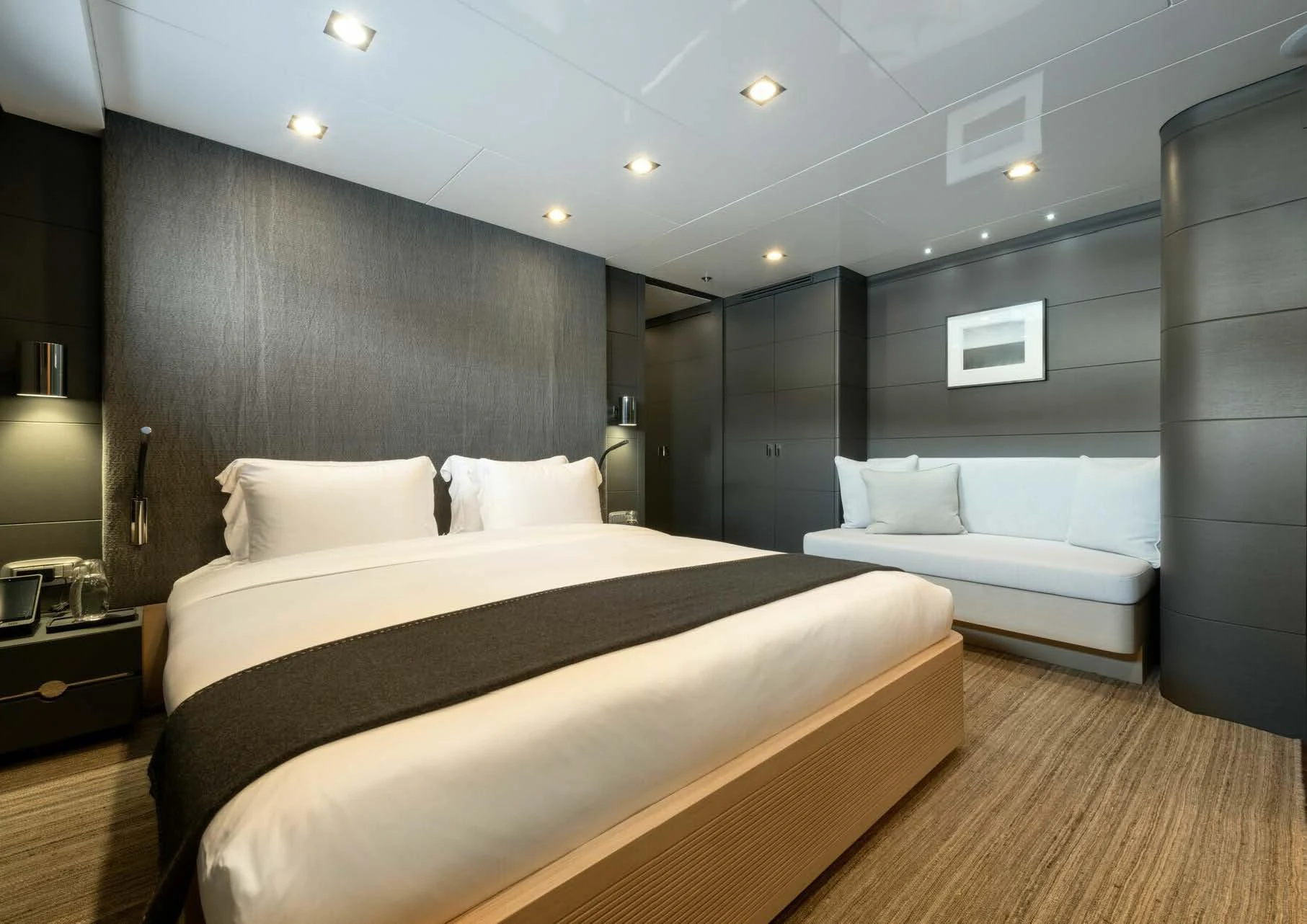 a bedroom with a bed and a couch aboard ZIA Yacht for Charter