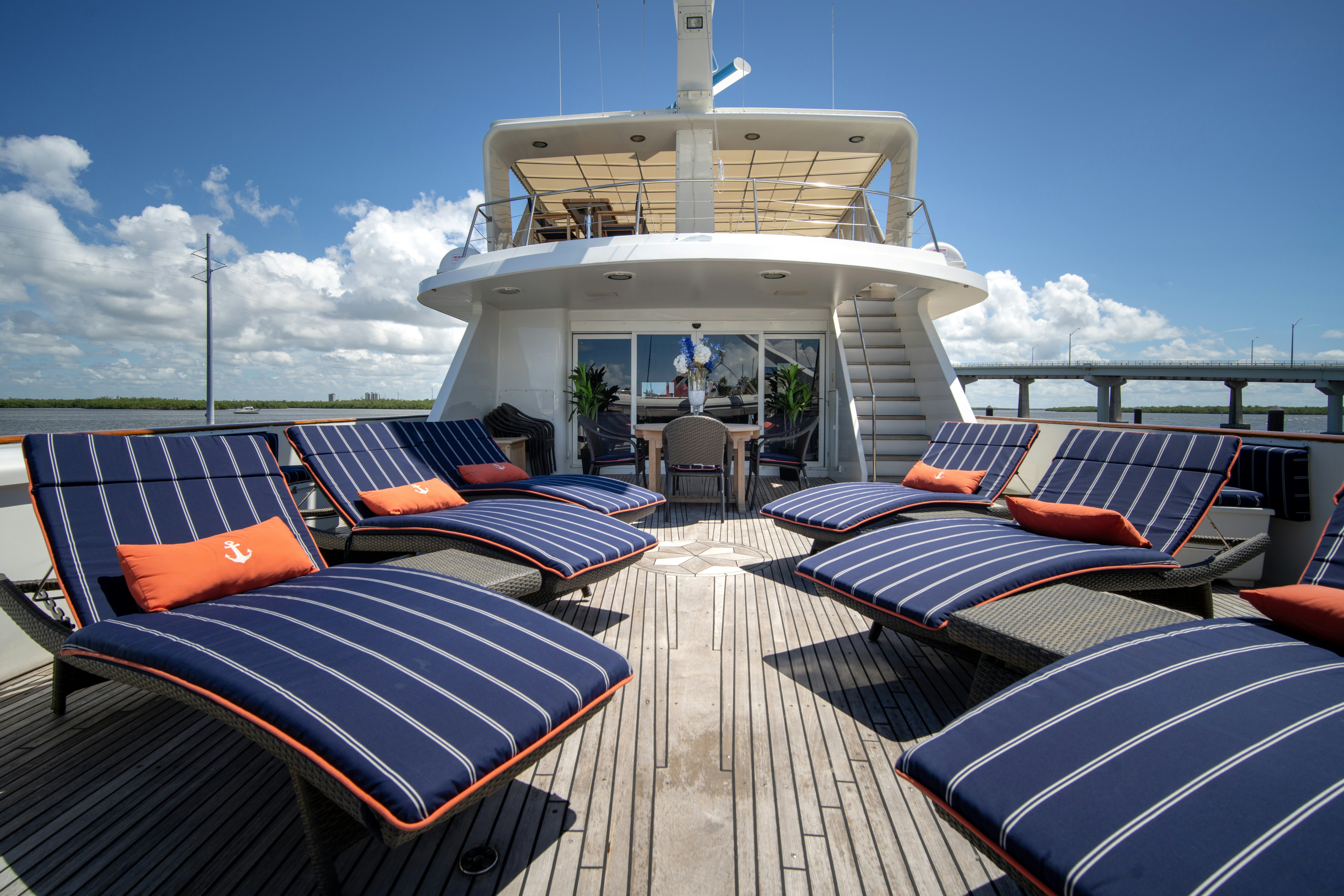 a deck with a large deck and chairs on it aboard FLYING DUTCHMAN Yacht for Sale