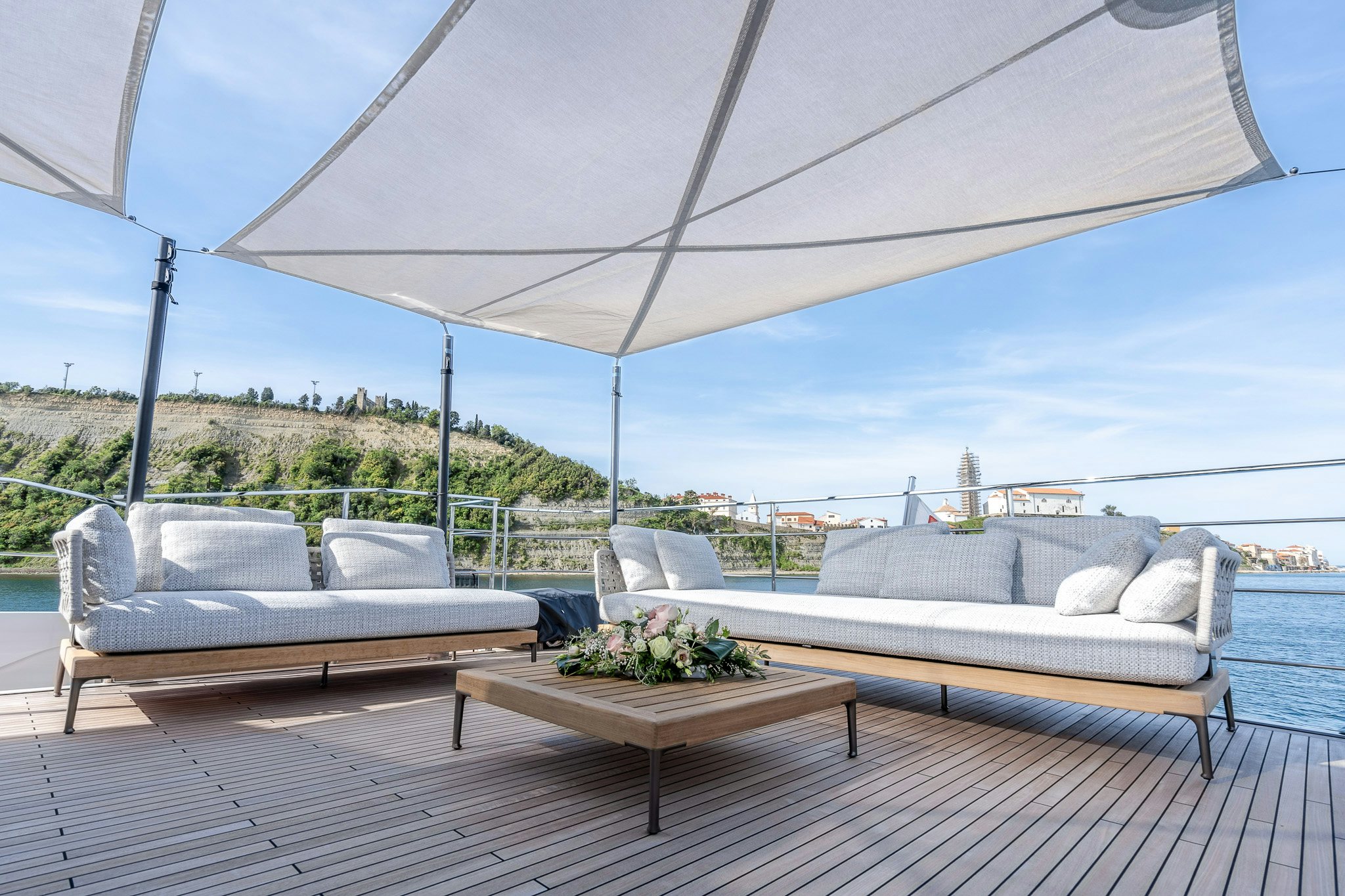 a patio with couches and a table on it aboard ISOTTA Yacht for Sale