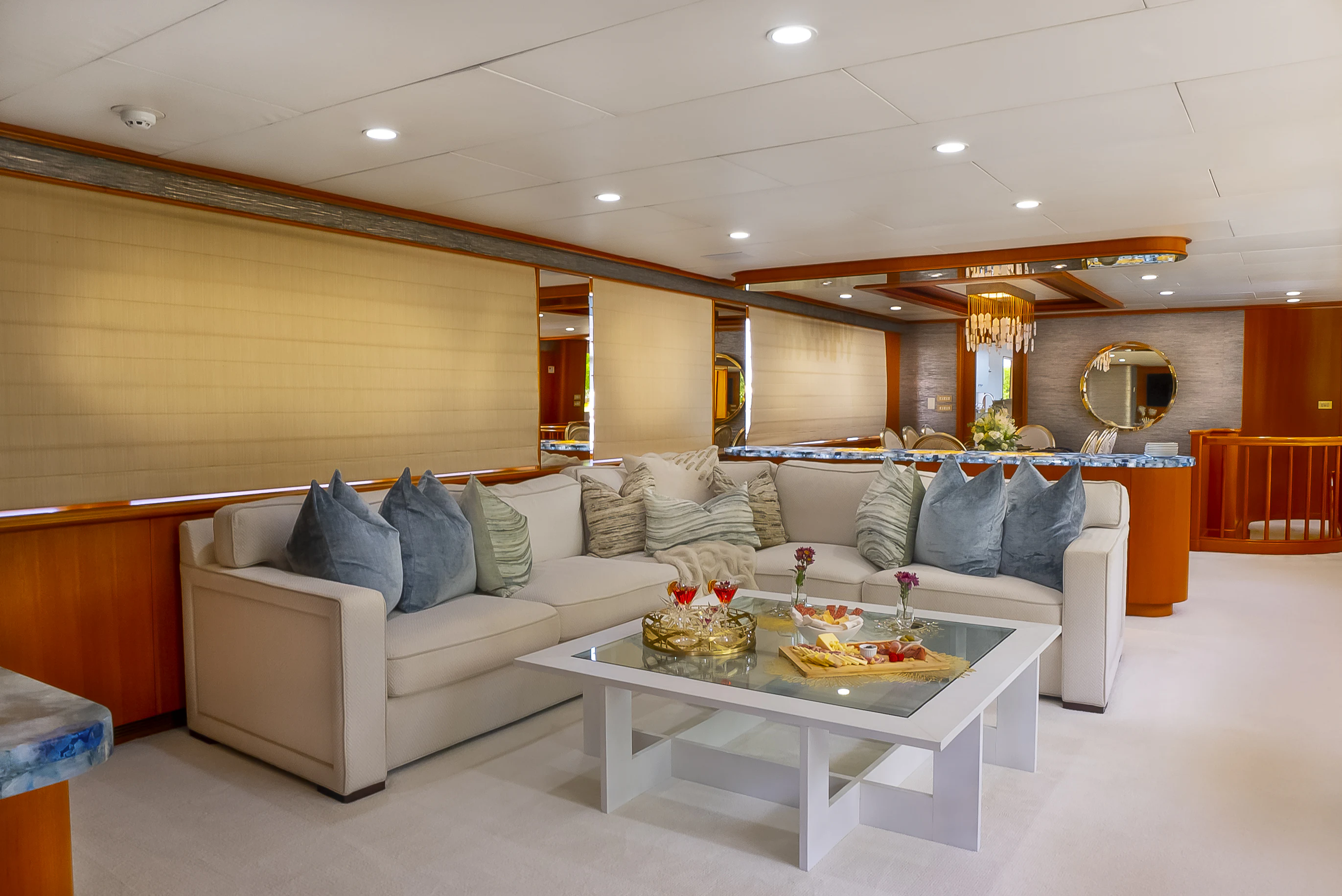a living room with a white couch and a round table aboard GALE WINDS Yacht for Charter
