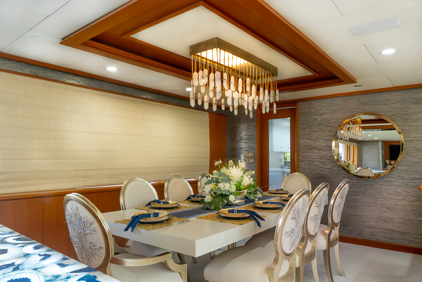 a dining room with a chandelier aboard GALE WINDS Yacht for Charter