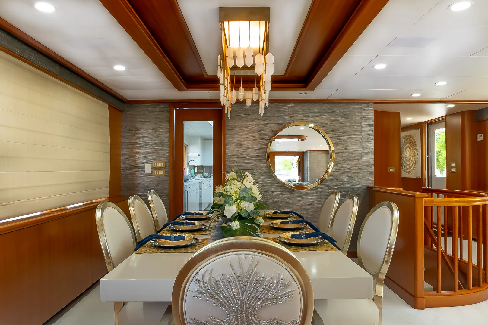 a dining table with chairs and a chandelier aboard GALE WINDS Yacht for Charter