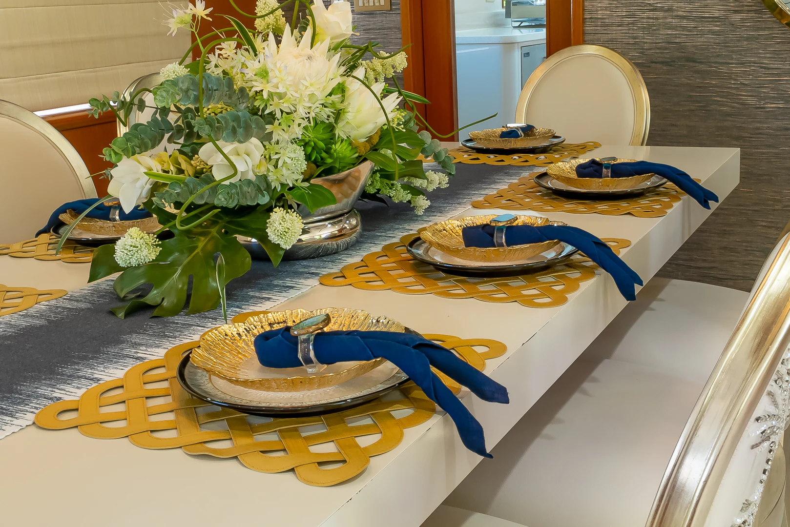 a table with plates and flowers aboard GALE WINDS Yacht for Charter