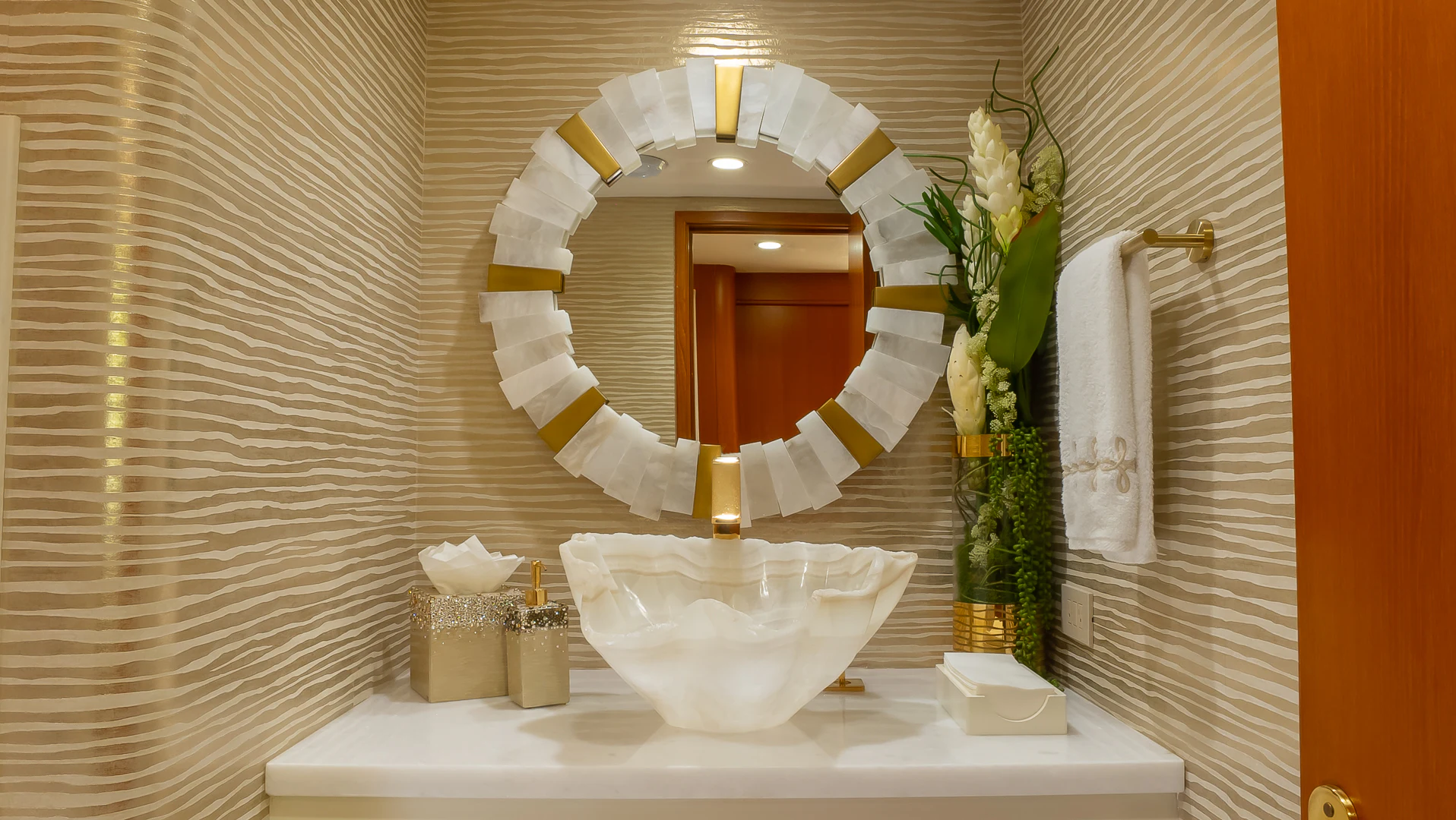 a white table with a white bowl and flowers in front of a mirror aboard GALE WINDS Yacht for Charter