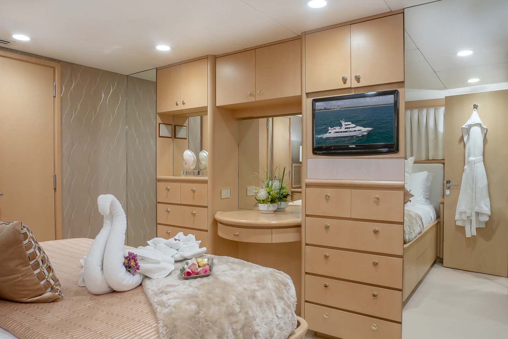 a bedroom with a tv and a bed aboard GALE WINDS Yacht for Charter