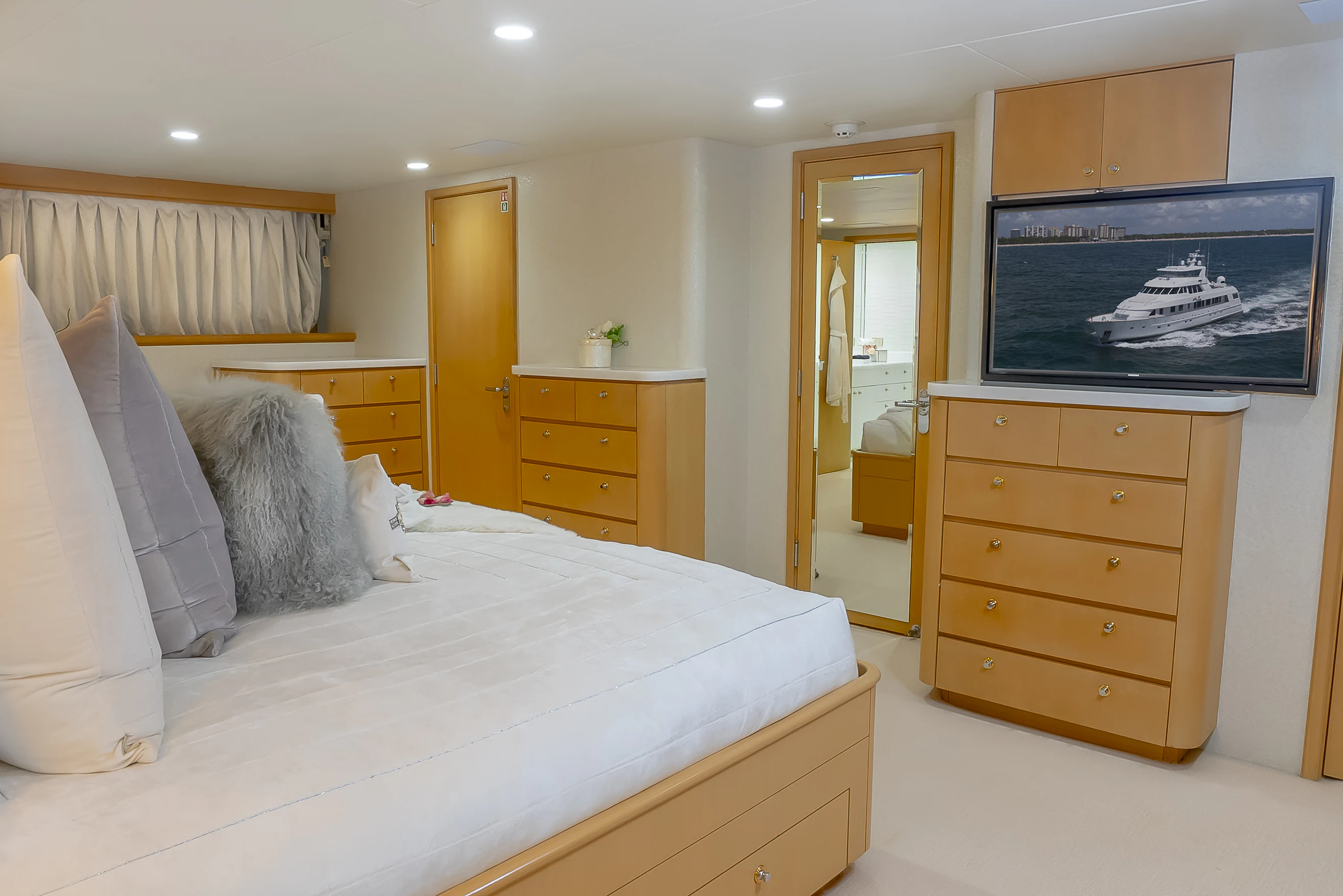 a bedroom with a bed and a tv on the wall aboard GALE WINDS Yacht for Charter